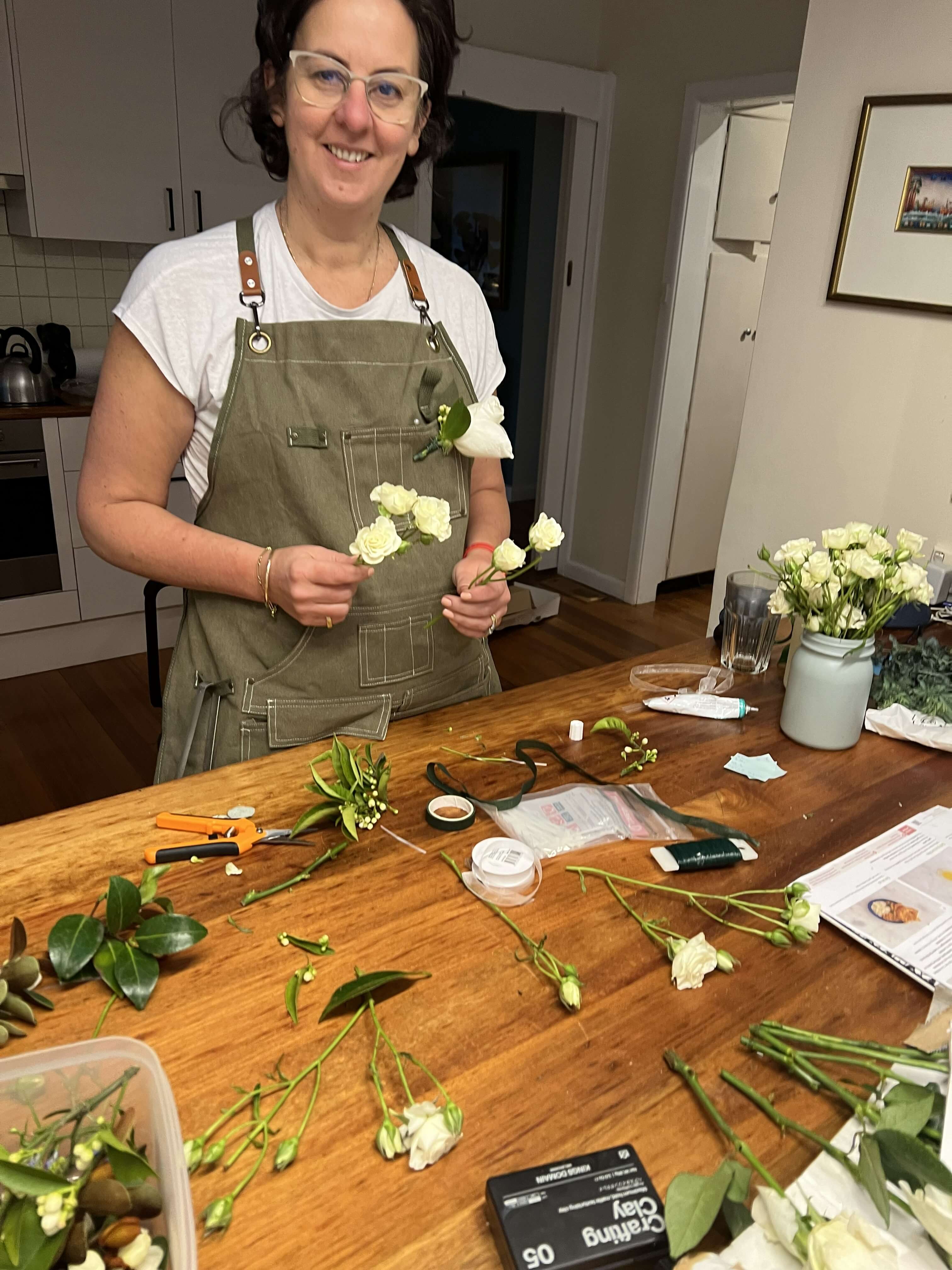 Blog writer arranging flowers at kitchen bench