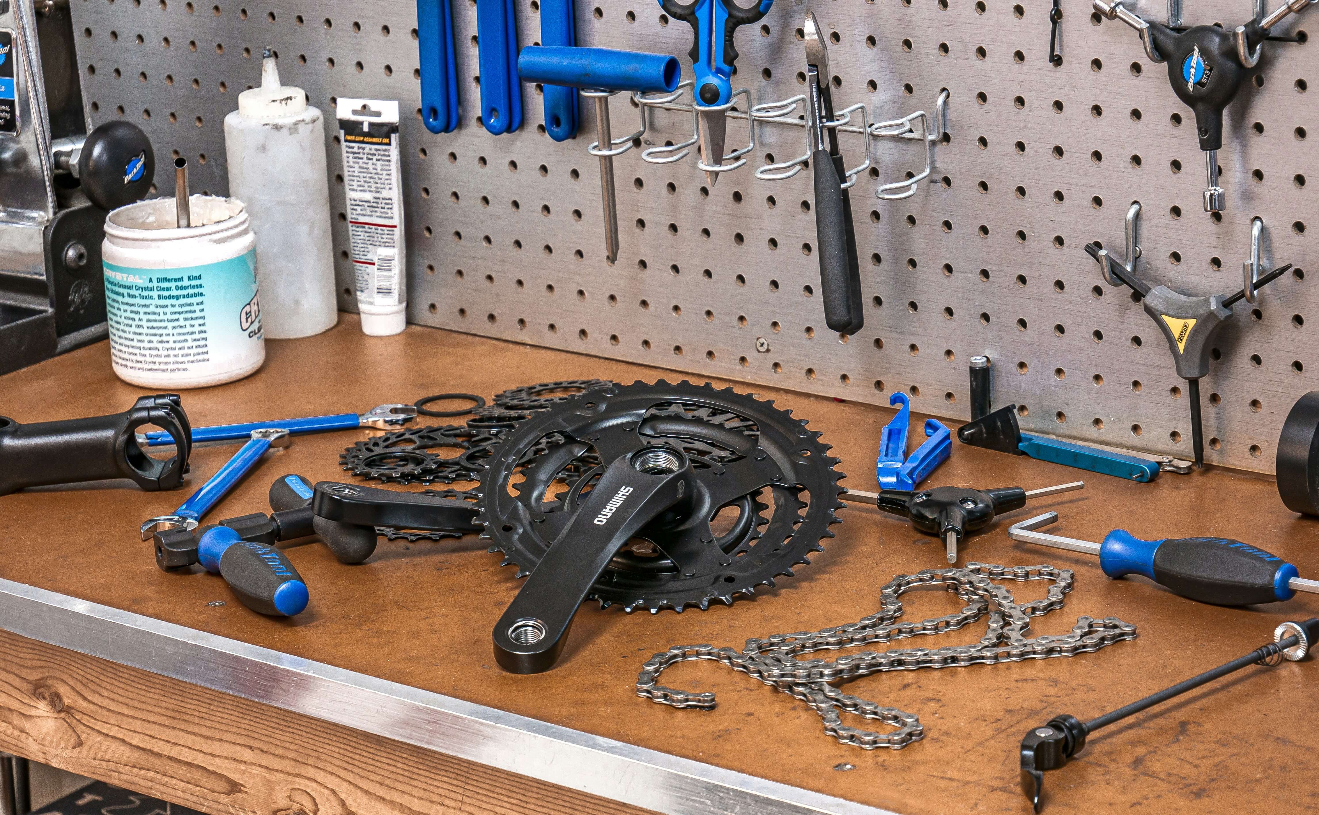 Bike parts on a work bench including gears and chain. Photo by <a href="https://unsplash.com/@tecreate?utm_source=unsplash&utm_medium=referral&utm_content=creditCopyText">Tom Conway</a> on <a href="https://unsplash.com/photos/black-mountain-bike-gear-set-A7Qi_0oqOqA?utm_source=unsplash&utm_medium=referral&utm_content=creditCopyText">Unsplash</a>